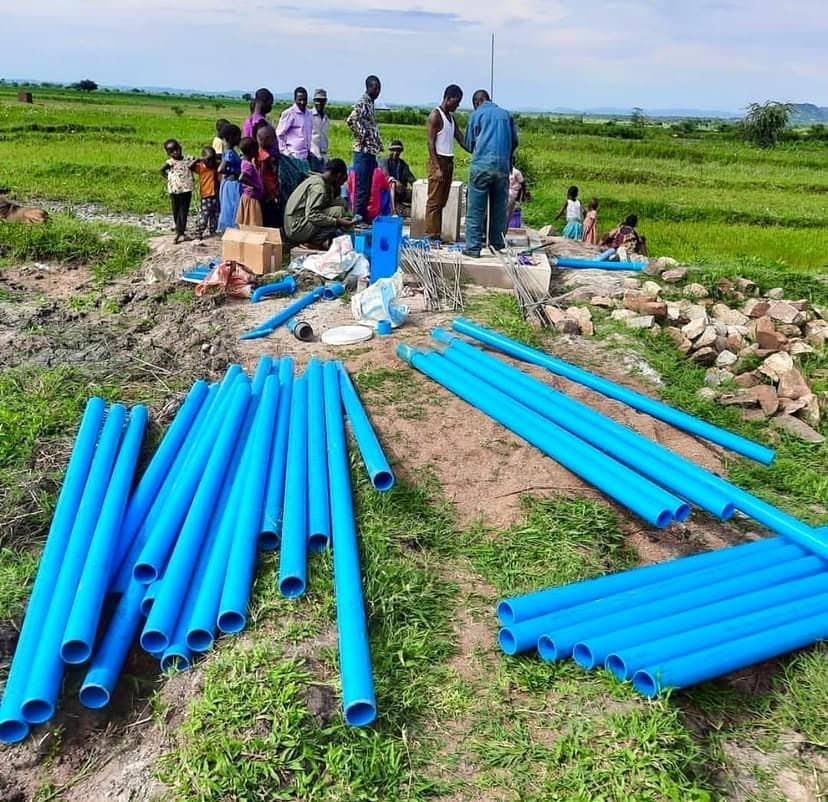 Technician servicing a well pump control panel